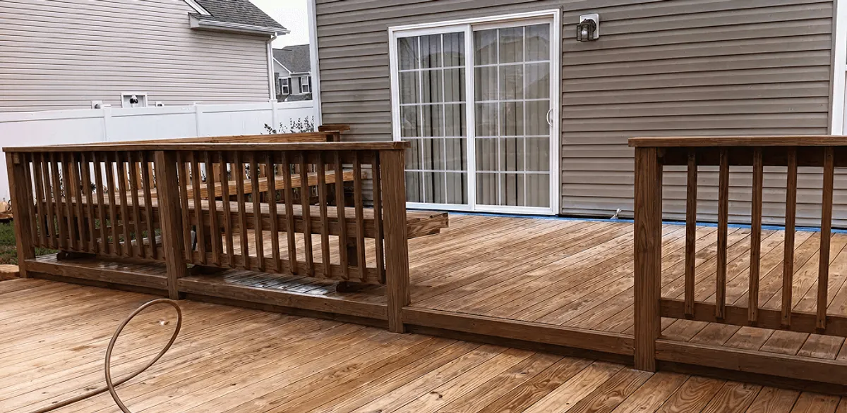 Deck sealing service protecting a backyard wood deck and railings in Nashville, TN