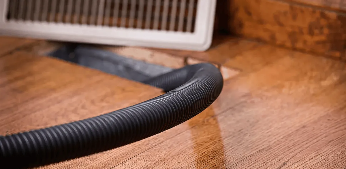Air duct cleaning hose inserted into a floor vent for ductwork cleaning in Nashville, TN