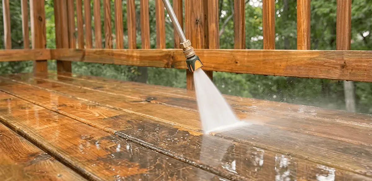 Pressure washing a wood deck to remove dirt and buildup in Nashville, TN