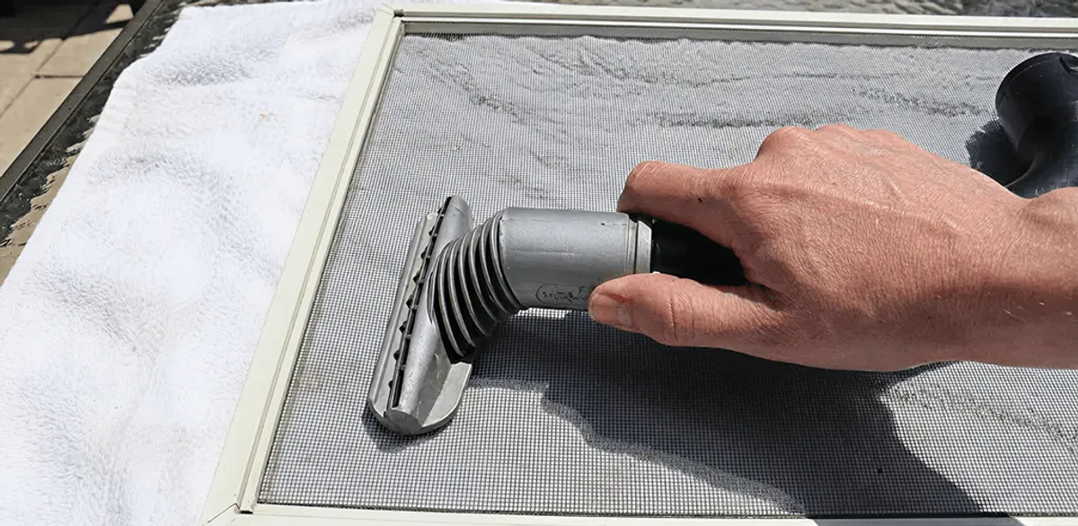 Window screen repair cleaning and fixing a damaged screen mesh in Nashville, TN