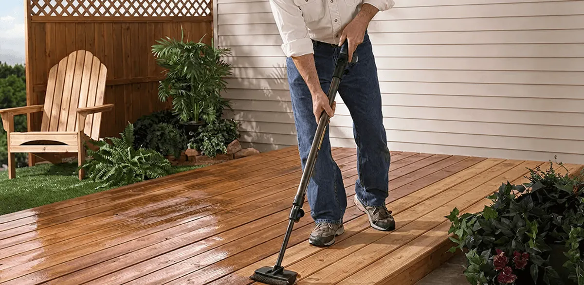 Deck staining service applying stain to a backyard wood deck in Nashville, TN